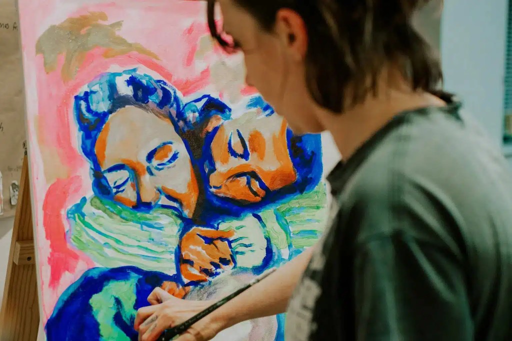 An artist painting a colorful portrait