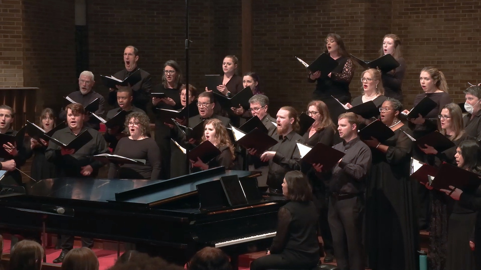 A choir performing with piano