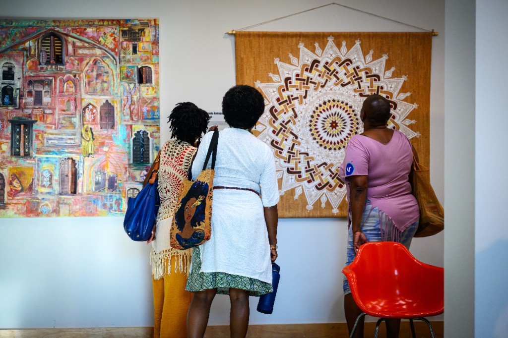 Visitors looking at artwork during an Artist Happy Hour