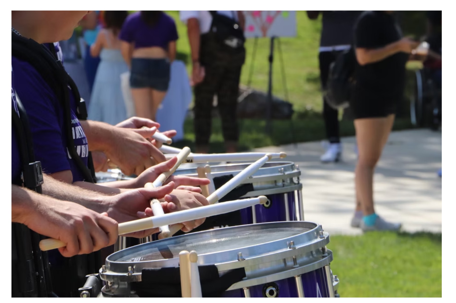 Performers and visitors at an outdoor arts festival